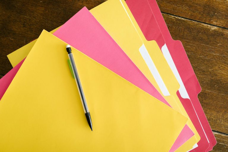 colorful folders and pen on the table